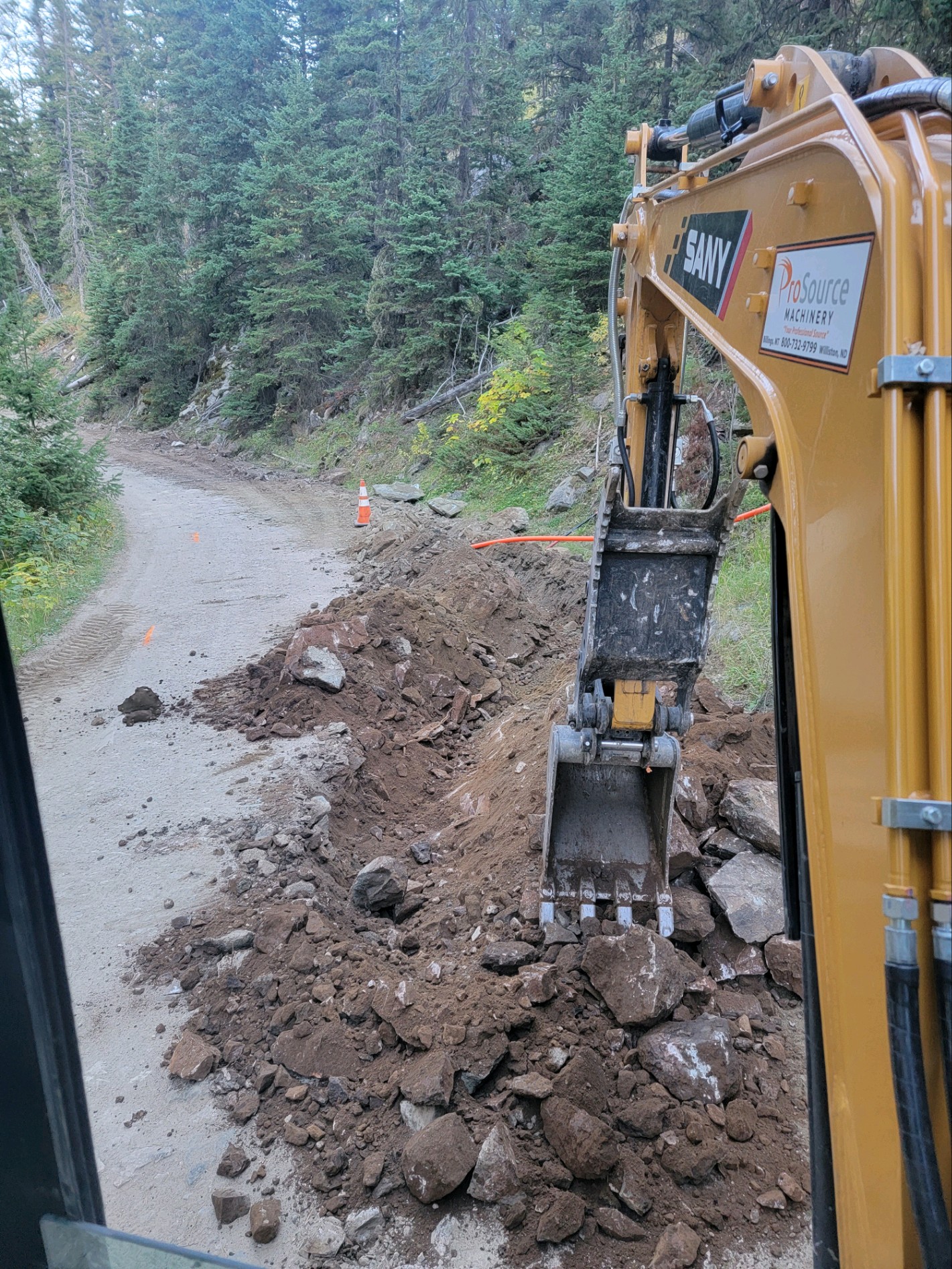 Yellow excavator digging